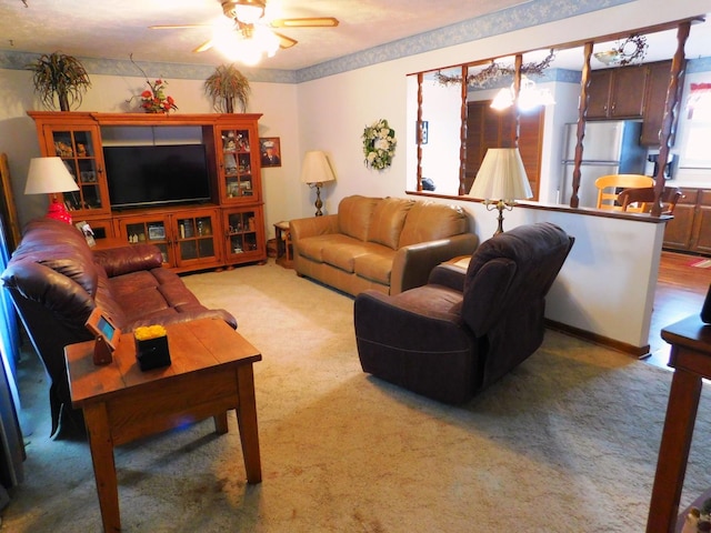 carpeted living room with ceiling fan