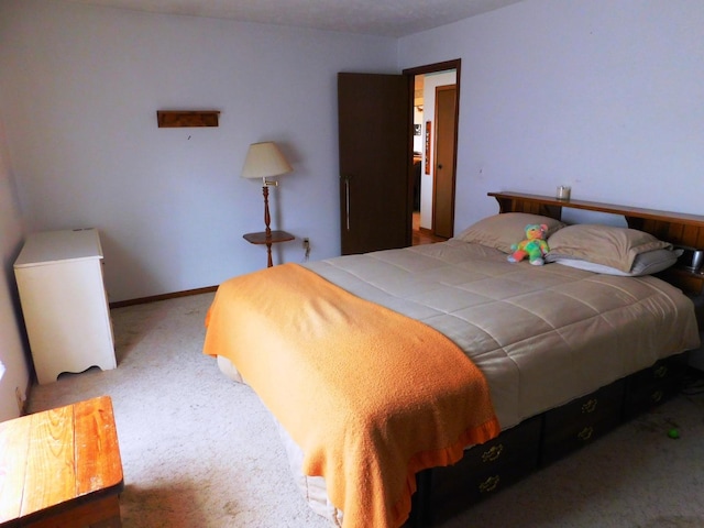 bedroom with carpet and baseboards