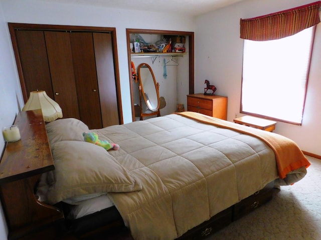 bedroom with carpet and multiple closets