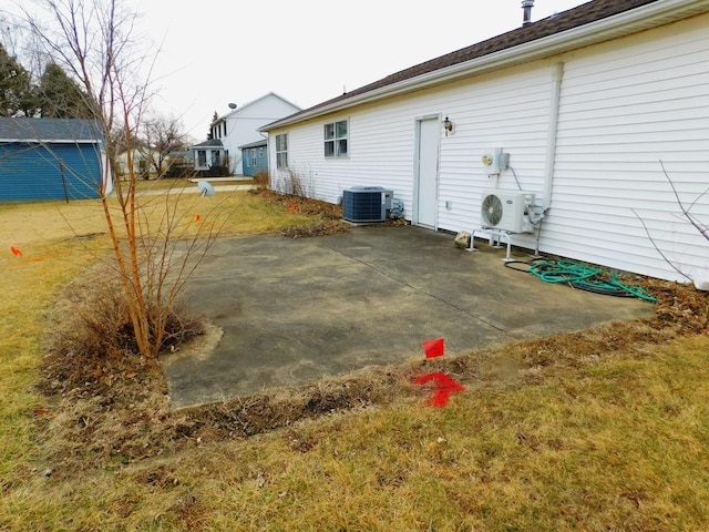 view of yard featuring a patio, central AC unit, and ac unit