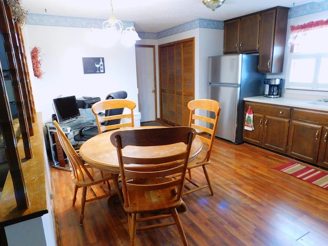 dining area with an inviting chandelier and wood finished floors