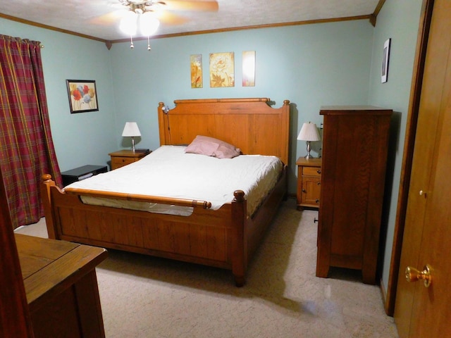 bedroom with ornamental molding, a ceiling fan, and light colored carpet