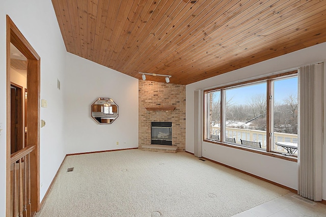 unfurnished living room with baseboards, a brick fireplace, wooden ceiling, and track lighting