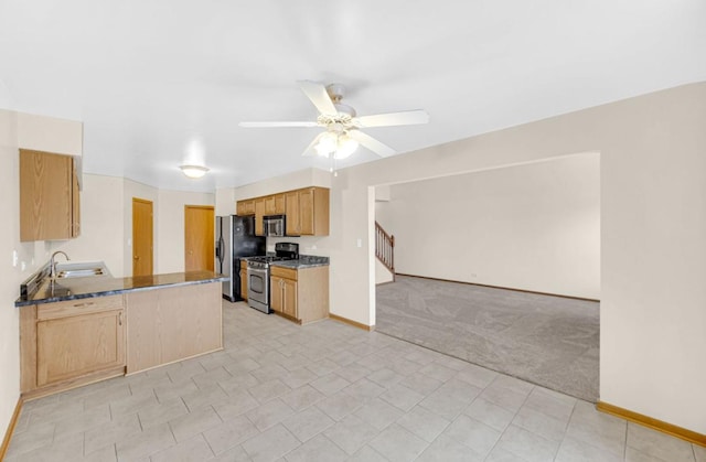 kitchen with ceiling fan, light colored carpet, a peninsula, open floor plan, and appliances with stainless steel finishes