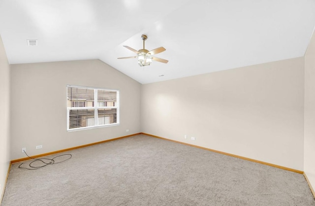 unfurnished room with lofted ceiling, carpet, baseboards, and a ceiling fan