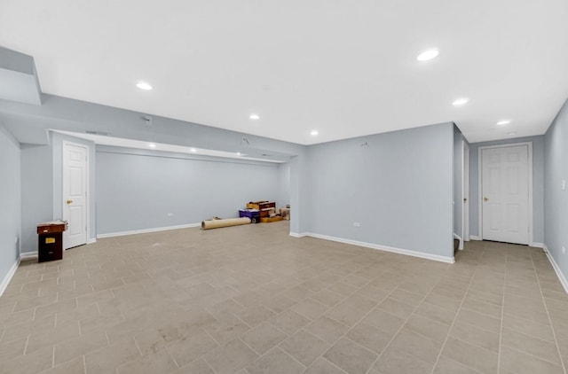 finished below grade area featuring visible vents, baseboards, and recessed lighting