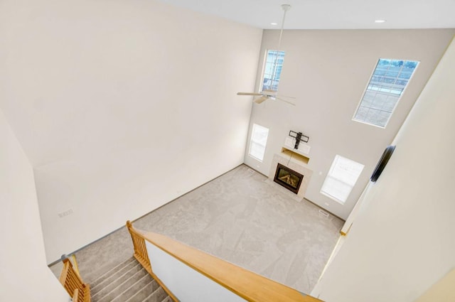 living room with a tiled fireplace, carpet, a ceiling fan, and recessed lighting