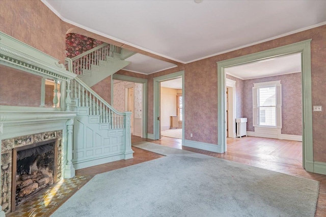 living room with baseboards, stairway, wood finished floors, and crown molding