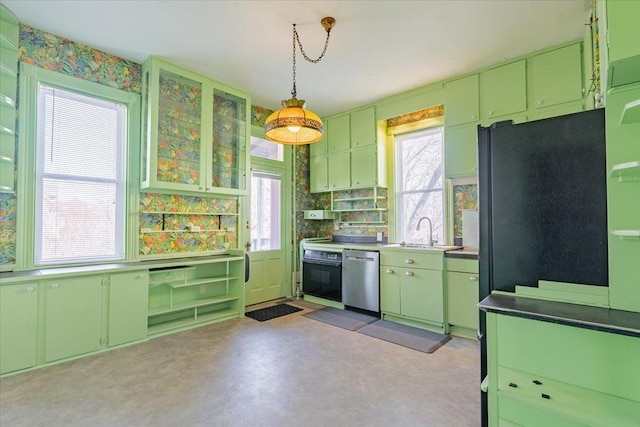 kitchen with green cabinets, black appliances, a sink, and a healthy amount of sunlight