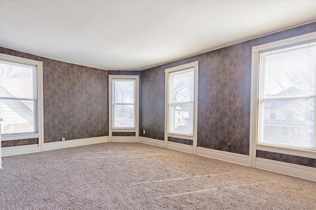 carpeted spare room with baseboards