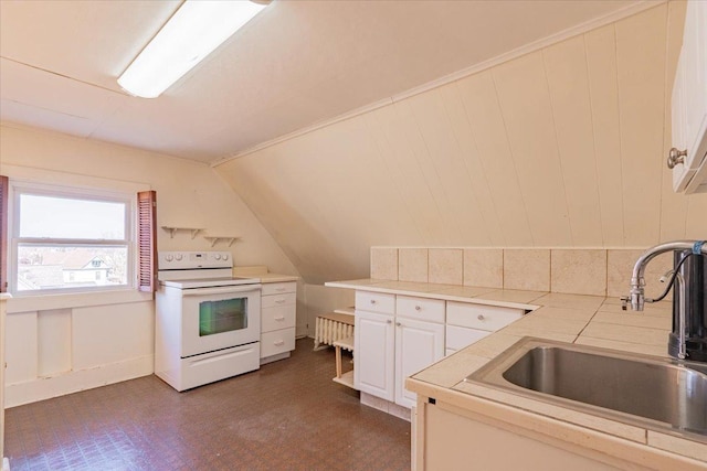 kitchen featuring electric range, lofted ceiling, dark floors, white cabinetry, and a sink