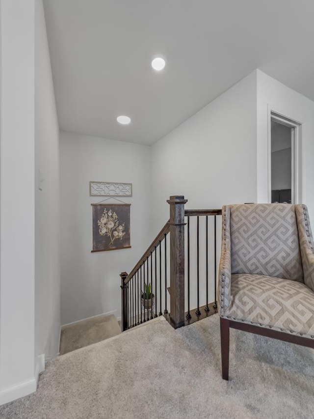 sitting room with carpet floors, recessed lighting, baseboards, and an upstairs landing