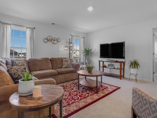 carpeted living room with visible vents and baseboards