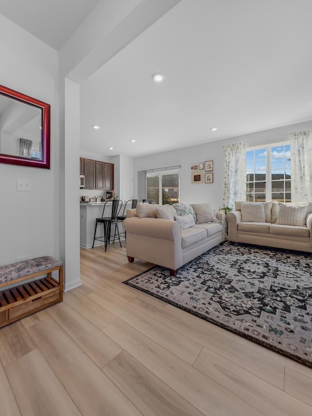 living area with light wood-style floors and recessed lighting