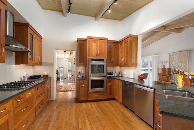 kitchen featuring wood ceiling, wall chimney range hood, beam ceiling, and appliances with stainless steel finishes