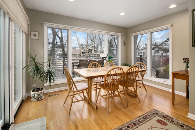 dining area with light wood-style flooring, recessed lighting, visible vents, and baseboards