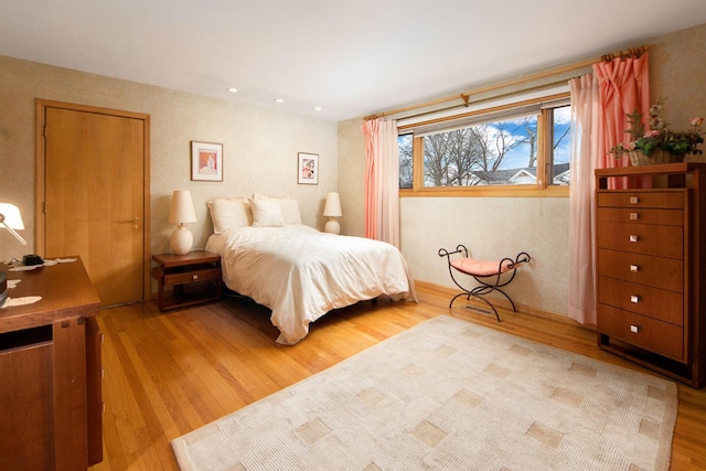 bedroom with wood finished floors and recessed lighting