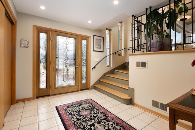 tiled foyer with stairs, visible vents, and recessed lighting