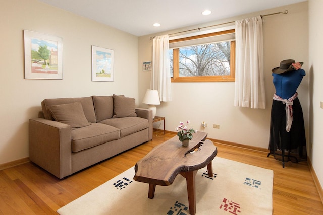 living area with light wood finished floors, baseboards, and recessed lighting