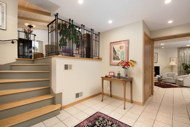 staircase featuring tile patterned flooring, visible vents, beamed ceiling, and recessed lighting