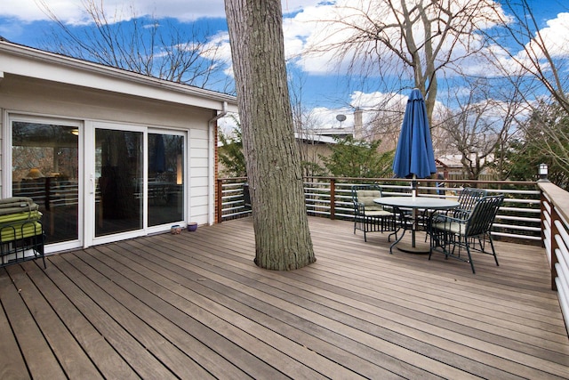 wooden deck featuring outdoor dining area