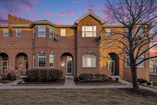 townhome / multi-family property with brick siding