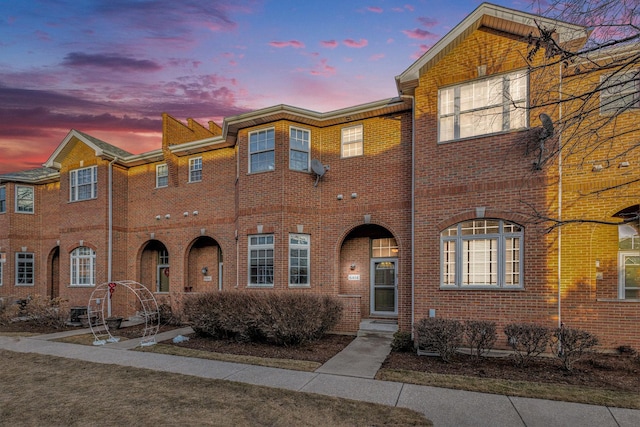 view of property with brick siding