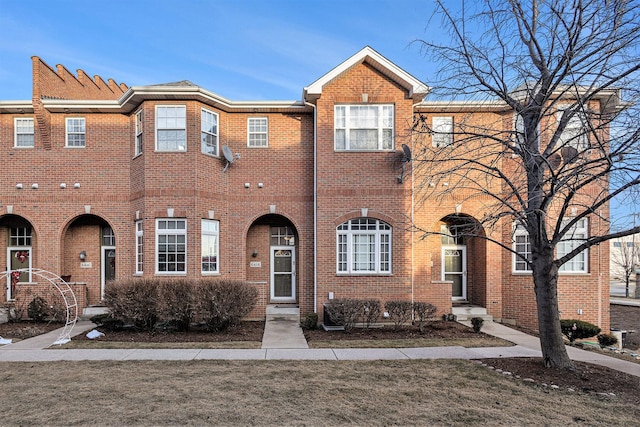 townhome / multi-family property featuring brick siding