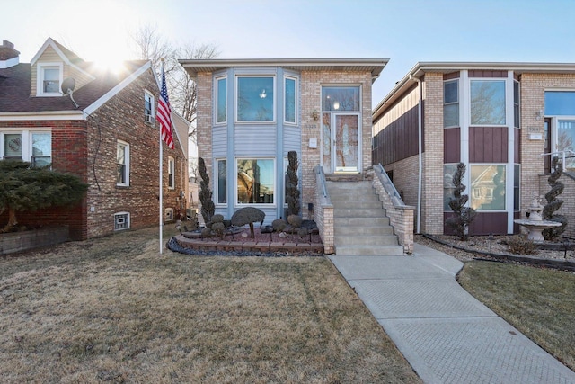 view of front of house with brick siding and a front yard