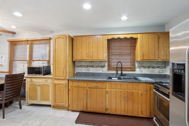 5326 S Nagle Ave, Chicago, IL 60638 - kitchen with appliances with stainless steel finishes, dark countertops, a sink, and a healthy amount of sunlight