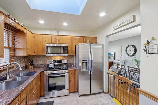 5326 S Nagle Ave, Chicago, IL 60638 - kitchen featuring stainless steel appliances, a sink, decorative backsplash, brown cabinetry, and dark countertops