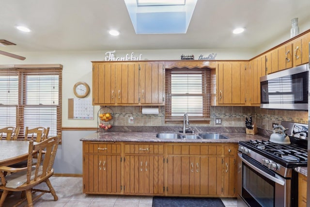 5326 S Nagle Ave, Chicago, IL 60638 - kitchen with light tile patterned floors, stainless steel appliances, a sink, visible vents, and decorative backsplash