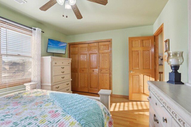 5326 S Nagle Ave, Chicago, IL 60638 - bedroom with baseboards, a closet, light wood-style flooring, and a ceiling fan