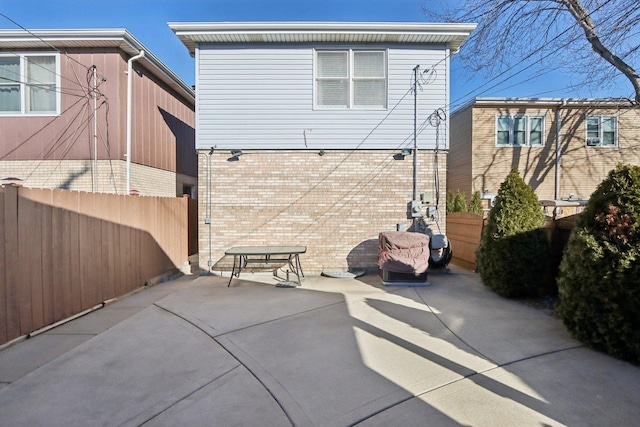 5326 S Nagle Ave, Chicago, IL 60638 - rear view of house featuring a patio area, fence, and brick siding