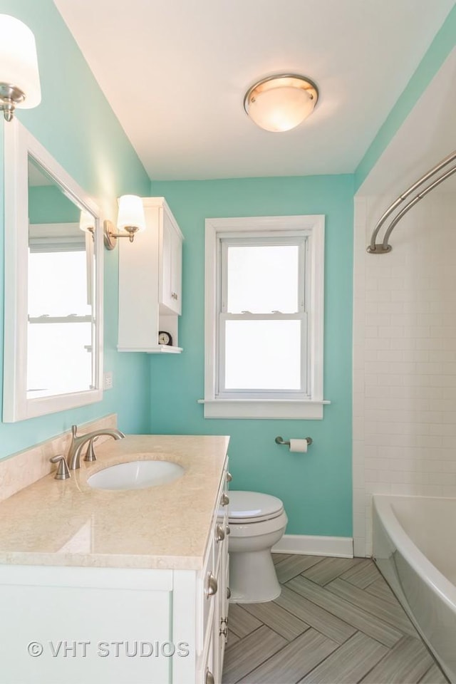 full bathroom featuring vanity, toilet, bathtub / shower combination, and baseboards