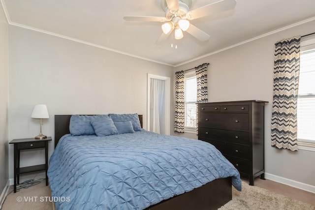 bedroom with light colored carpet, a ceiling fan, baseboards, and ornamental molding