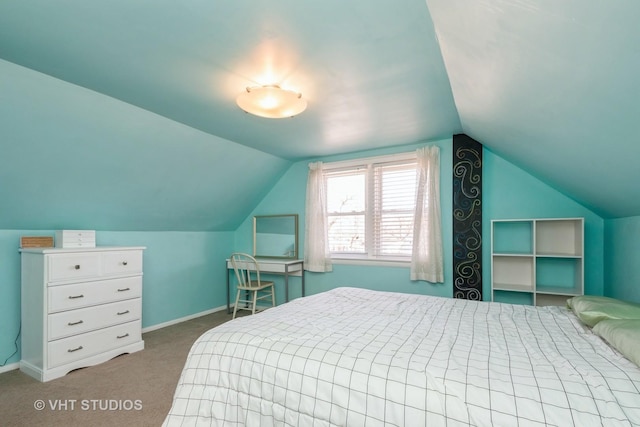 carpeted bedroom with vaulted ceiling and baseboards