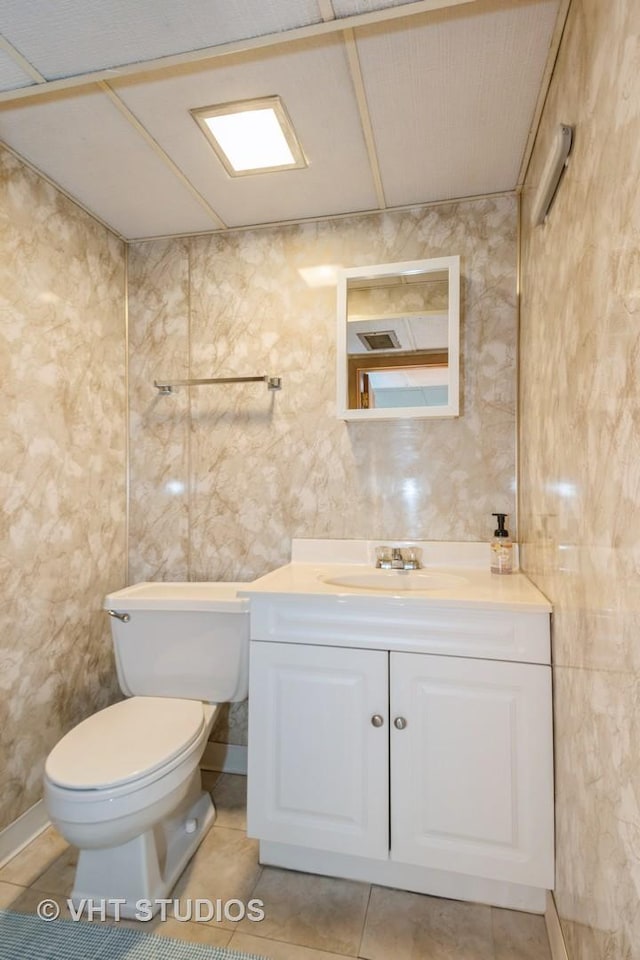 bathroom with tile patterned flooring, toilet, and vanity