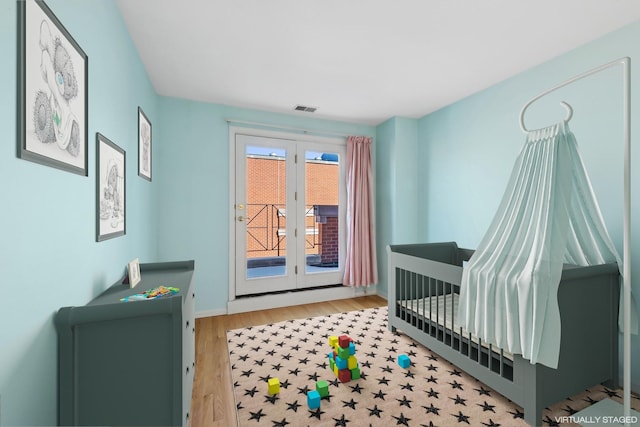 interior space featuring baseboards, visible vents, and wood finished floors