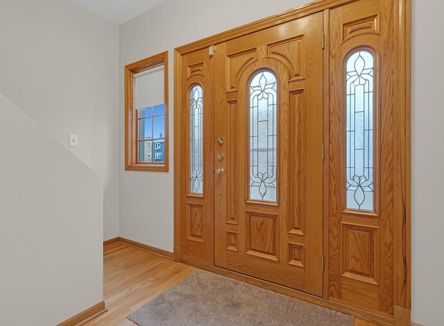 entrance foyer featuring light wood-style flooring and baseboards