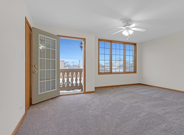 spare room with ceiling fan, baseboards, and carpet flooring