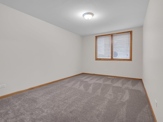 carpeted empty room with baseboards