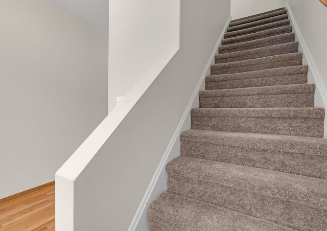 staircase with wood finished floors