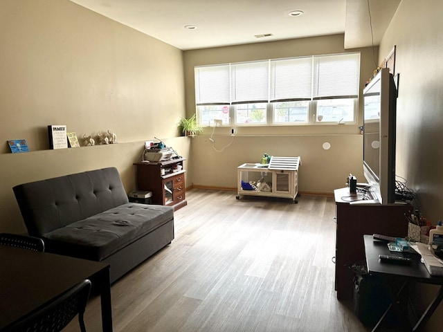 living area featuring wood finished floors and baseboards