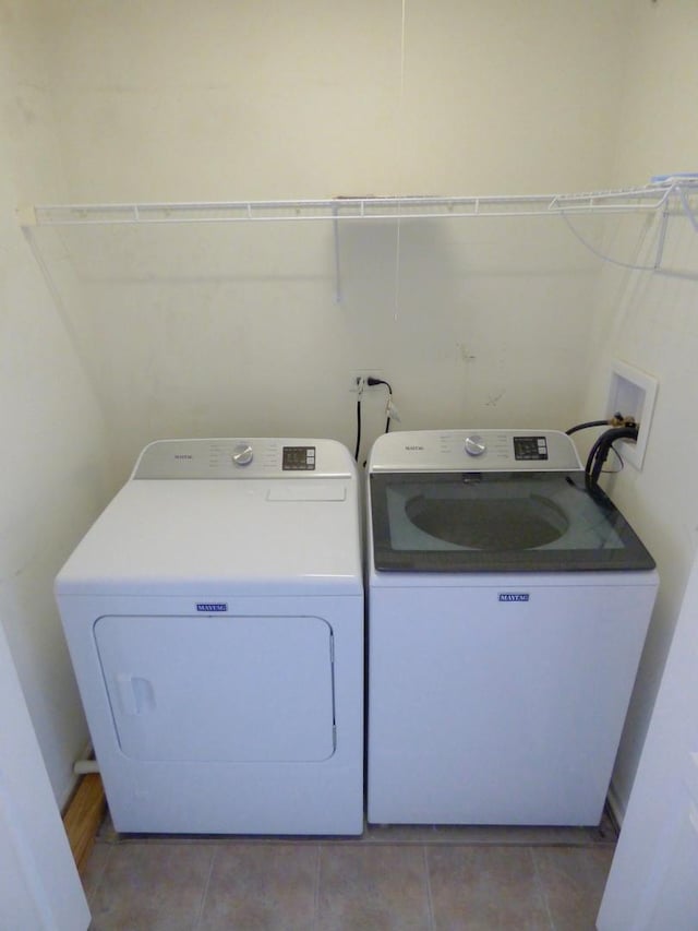 laundry room with light tile patterned floors, laundry area, and separate washer and dryer