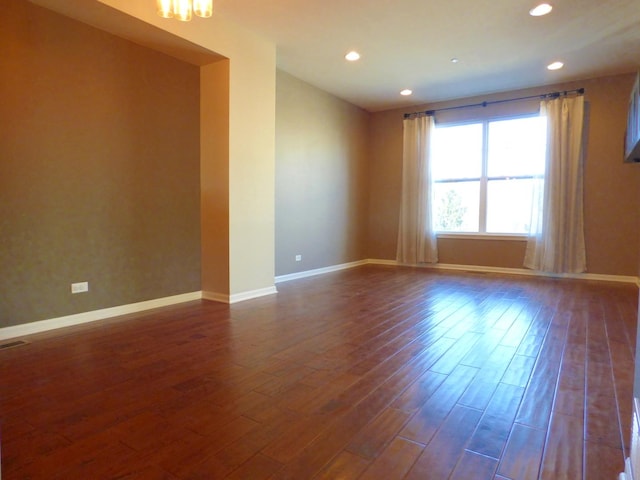 unfurnished room with dark wood-type flooring, recessed lighting, and baseboards