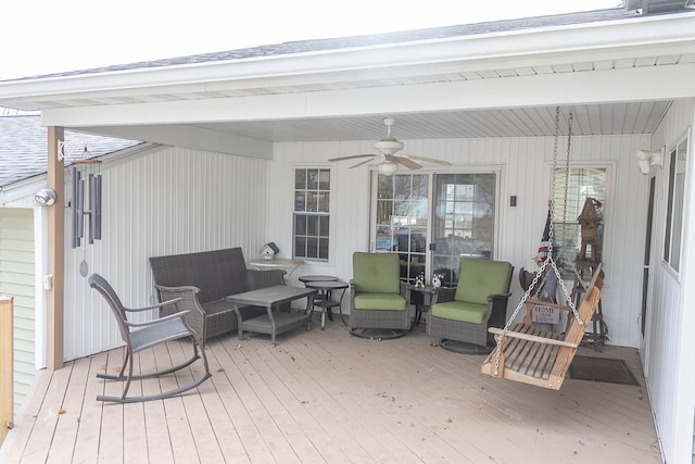 wooden terrace with ceiling fan and an outdoor hangout area