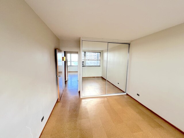 5532 S Shore Dr Unit 6E, Chicago, IL 60637 - unfurnished bedroom with baseboards and a closet