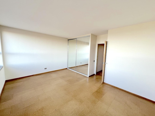 5532 S Shore Dr Unit 6E, Chicago, IL 60637 - unfurnished bedroom featuring a closet and baseboards