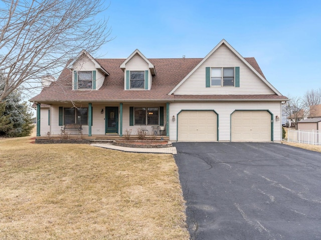 view of front of home featuring aphalt driveway, roof with shingles, a porch, a garage, and a front lawn